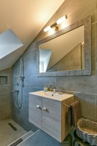 a bathroom with a sink and a mirror at Szent Kristóf Panzió in Eger