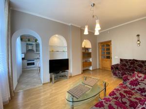 a living room with a couch and a table at Imanta Apartment in Daugavpils