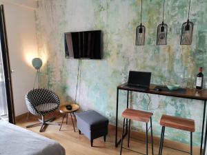 a bedroom with a bed and a desk with a laptop at Wellport30 in Belgrade