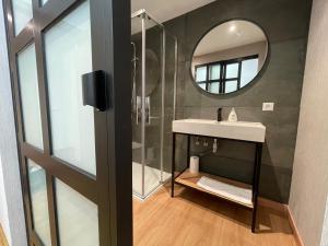 a bathroom with a sink and a mirror at Oktheway Pedro Saco Street in Sarria