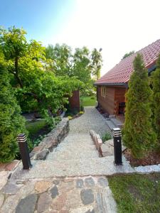 a garden with a stone path leading to a house at Mazurski Domek in Mikołajki