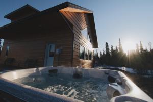 a hot tub in front of a house at Denali Wild Stay - Bear Cabin with Hot Tub and Free Wifi, Private, sleep 6 in Healy