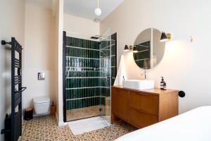 a bathroom with a sink and a shower with a mirror at Cycle Coffee Society House Ventoux in Bédoin +12 photos