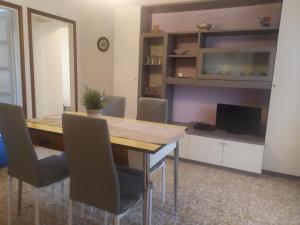 a dining room with a wooden table and chairs at Casa del Fra' in Plesio