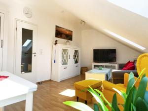 a living room with a couch and a tv at Antje's Ferienwohnung Rastede in Rastede