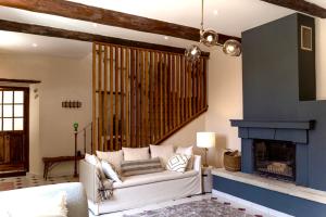 a living room with a white couch and a fireplace at Cycle Coffee Society House Ventoux in Bédoin