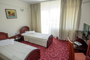 Postel nebo postele na pokoji v ubytování Hotel Scala