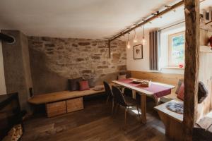 a dining room with a table and chairs at Chalet Passeier - RIVER in Saltusio