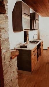 a kitchen with a stove and a counter top at Il nido di Lele e Schina in Arvier