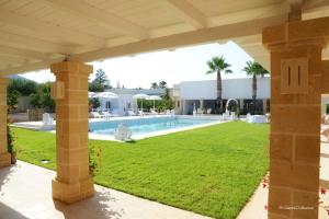 a view of a swimming pool and a yard at Don Onofrio in Monopoli