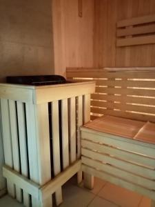 a wooden bench sitting next to a wooden wall at Эврика! Апартаменты с сауной в частном доме in Velikiy Novgorod