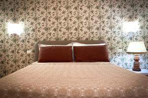 Un pat sau paturi într-o cameră la Villa Bagnara