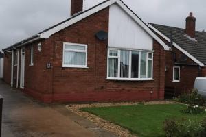 a red brick house with white windows and a driveway at 18 Sea View Close in Scarborough