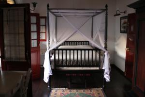 a bed with a canopy in a room at Royal Bar & Hotel in Kandy