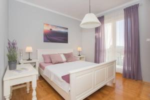 Postel nebo postele na pokoji v ubytování Dalma Residence apartman Lavandella