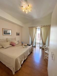 a bedroom with a large bed and a chandelier at B&B Evelyne in Taormina