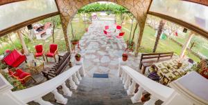 an overhead view of a pathway with benches and chairs at villa Touzla in Ofrínion