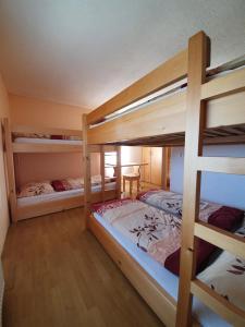 a bedroom with two bunk beds with a table at Pr` Florjan in Cerklje na Gorenjskem