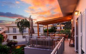 a balcony with a sunset view of a house at Bitsakis Family II - Paleochora Luxury House in Palaiochóra