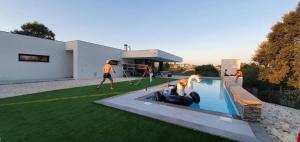 a group of people playing in a swimming pool at Villa Casa Tranquilespiral Alcobaça-Nazare in Mendalvo