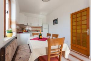 a kitchen with a table with a bottle of wine on it at Apartment and Rooms Villa Marijo in Dubrovnik