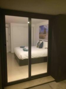 a reflection of a bedroom with a bed in a mirror at Villa Casa Tranquilespiral Alcobaça-Nazare in Mendalvo +41 photos