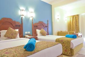 Ein Bett oder Betten in einem Zimmer der Unterkunft Jasmine Palace Resort