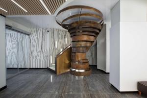 a spiral staircase in a room with wood floors at NH Madrid Chamberí in Madrid