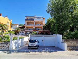 a car parked in a garage in front of a house at Apartment in Crikvenica 5155 in Crikvenica