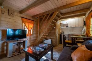 a living room with a couch and a tv and a table at Brvnara Fairy Tale in Cetinje