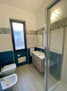 a bathroom with a toilet and a sink and a shower at Cala Gonone - Casa del Mirto in Cala Gonone +32 photos