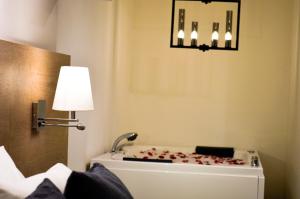 a room with a bath tub with a light and a lamp at Casa Bella Boutique Hotel in Antigua Guatemala +90 photos