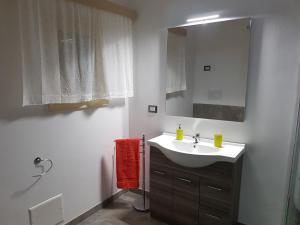 une salle de bain avec un lavabo et un miroir dans l'établissement Casa Vacanze Nonna Maria, à Carpignano Salentino