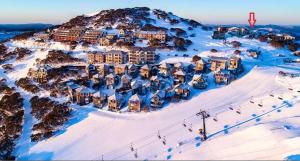 an aerial view of a resort in the snow at Alpine Cabin- Spa/Pool/Sauna in Mount Hotham