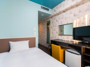 Кровать или кровати в номере Hotel Wing International Chitose