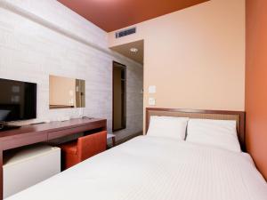 Кровать или кровати в номере Hotel Wing International Chitose