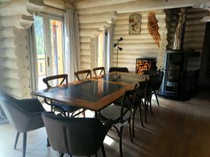 a dining room with a wooden table and chairs at L'Edelweiss in Allos