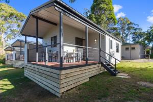 a house with a wrap around porch with a deck at Mittagong Caravan Park in Mittagong