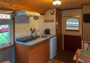 a kitchen with a sink and a counter top at De Wagen in Egmond-Binnen