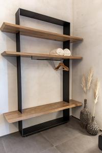 a set of wooden shelves in a room with a vase at Lethe Villas with Private Pool Kato Gatzea Greece in Kato Gatzea