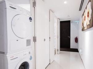 a laundry room with a washer and dryer at Heritage Collection on Seah - Mobile App Check-In in Singapore
