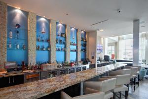 a bar in a restaurant with a blue wall at Hotel Indigo Waco, an IHG Hotel in Waco