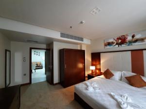 a bedroom with a large bed and a living room at SBY Hotel فندق اس بي واي in Jeddah +28 photos