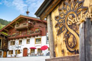 a large building with a red and white at Pension Seighof in Saalbach Hinterglemm