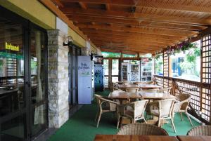 an empty restaurant with tables and chairs on a patio at Pensiunea Delta Dunarii in Tulcea
