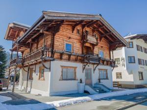 a wooden building with balconies on the side of it at Chalet Kirchberg L in Kirchberg in Tirol