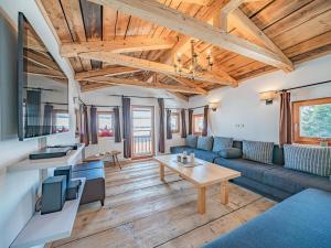 a living room with a couch and a table at Chalet Kirchberg L in Kirchberg in Tirol