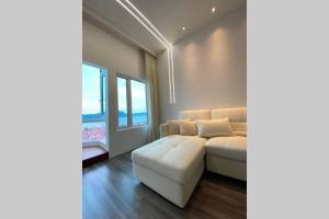 a living room with a white couch and a window at Ikiru Japanese Tatami Convenient Seaview Apartment in Kuah
