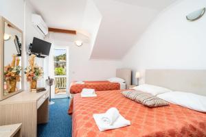 Postel nebo postele na pokoji v ubytování Hotel Dubrovnik