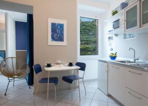 a kitchen with a table and chairs and a sink at Appartamenti Da Paulin in Manarola